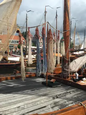 a group of boats tied to a dock with nets at Holiday in Spakenburg Groof in Spakenburg