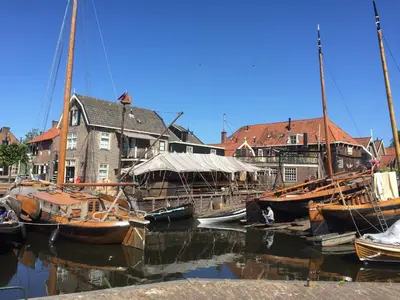 a group of boats are docked in a harbor at Holiday in Spakenburg Groof in Spakenburg