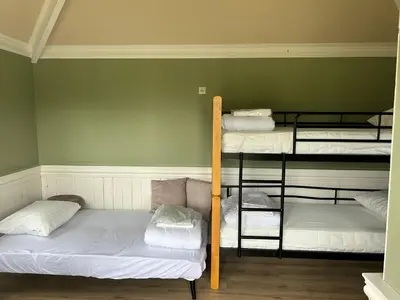 a room with three bunk beds in a room at Camping De Boerinn in Kamerik