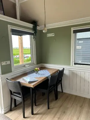 a dining room with a wooden table and chairs at Camping De Boerinn in Kamerik
