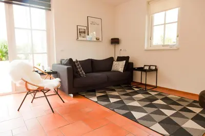 a living room with a couch and a checkered floor at Het Eerste Huisje vacation home in Noordwijk aan Zee