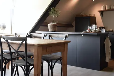 a dining room with a wooden table and chairs at Bedje in de polder in Montfoort