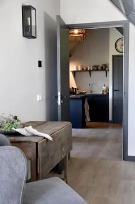 a living room with a table and a kitchen at Bedje in de polder in Montfoort