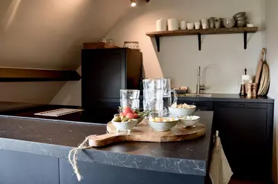 a kitchen counter with bowls of fruit on a cutting board at Bedje in de polder in Montfoort