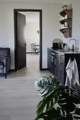 a kitchen with a door leading to a dining room at Bedje in de polder in Montfoort