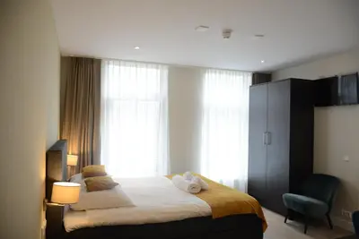 a bedroom with a bed and a window at NL Hotel District Leidseplein in Amsterdam