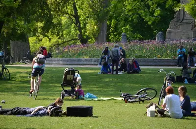 a group of people sitting on the grass in a park at NL Hotel District Leidseplein in Amsterdam