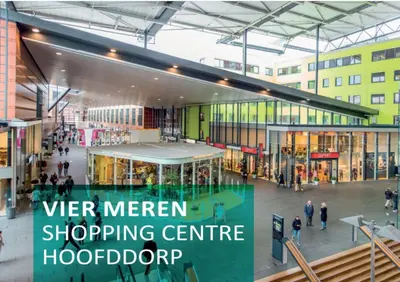 a shopping center with people walking in a mall at Hotel De Rustende Jager in Nieuw-Vennep