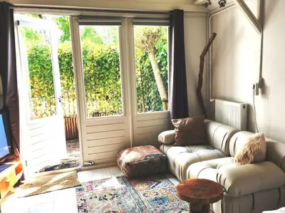 a living room with a couch in front of a door at Little Villa Lovely in Bergen
