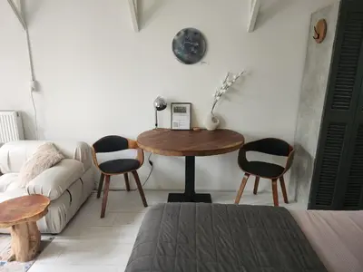 a living room with a table and chairs and a couch at Little Villa Lovely in Bergen