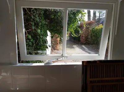 an open window with a view of a garden at Little Villa Lovely in Bergen