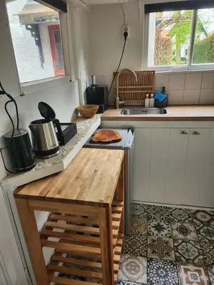 a kitchen with a table with a pizza on it at Little Villa Lovely in Bergen