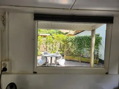 a view of a table and chairs through a window at Little Villa Lovely in Bergen