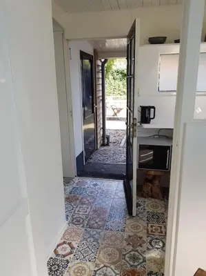a hallway of a house with a door and a tile floor at Little Villa Lovely in Bergen