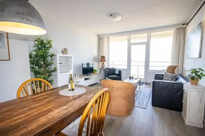 a living room with a dining table and a living room at The Lookout in Egmond aan Zee