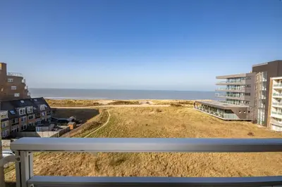 a view of the beach from the balcony of a building at The Lookout in Egmond aan Zee