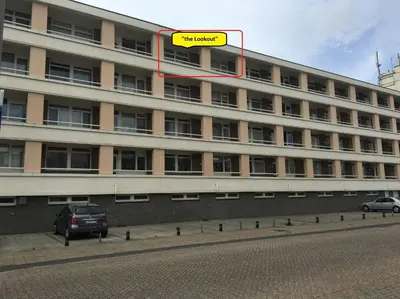 a building with a yellow sign on top of it at The Lookout in Egmond aan Zee