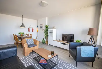 a living room with a couch and a table at The Lookout in Egmond aan Zee