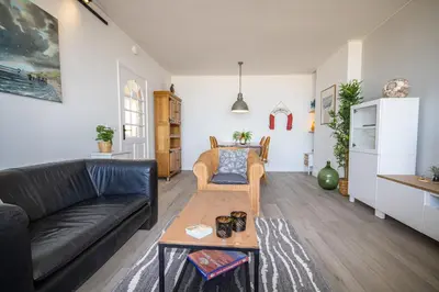 a living room with a couch and a table at The Lookout in Egmond aan Zee