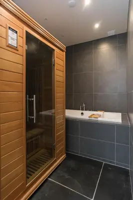 a bathroom with a large shower and a tub at Six Boutique Hotel in Haarlem
