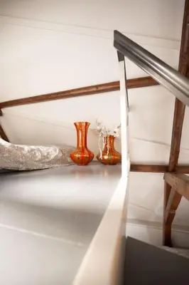 two vases and a knife on a shelf at De Kapelle in Oudewater in Oudewater
