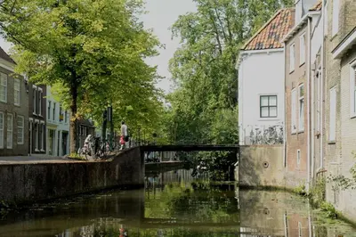 a bridge over a river in a city with buildings at De Kapelle in Oudewater in Oudewater