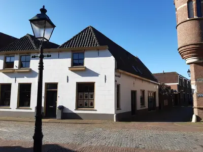 a street light in front of a white building at De Kapelle in Oudewater in Oudewater