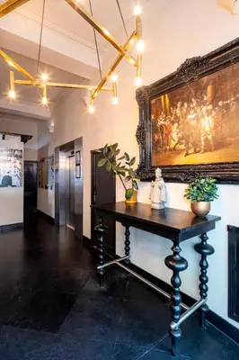 a room with a table and a painting on the wall at Hotel Sint Nicolaas in Amsterdam