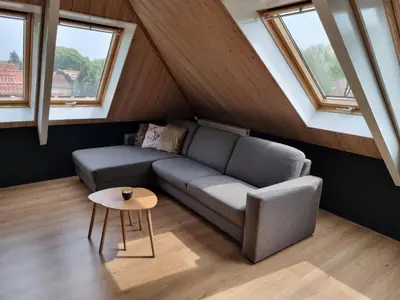 a living room with a couch and a table at Aan de Burgwal in Enkhuizen
