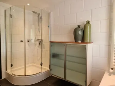 a bathroom with a shower with a glass door at Aan de Burgwal in Enkhuizen