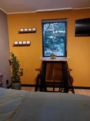 a room with a bed and a window with a table at Aan de Burgwal in Enkhuizen