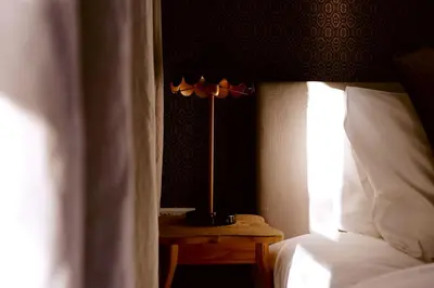 a lamp on a night stand next to a bed at Boetiekhotel De Kastanjehof in Lage-Vuursche