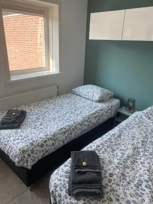 a room with two beds and a window at Apartment de Boer in Zandvoort