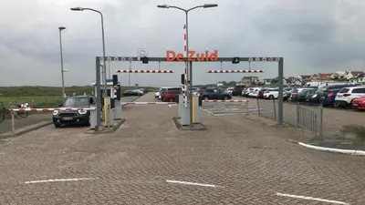 a parking lot with a lot of cars parked at Apartment de Boer in Zandvoort
