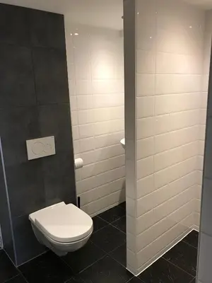 a bathroom with a white toilet in a stall at Apartment de Boer in Zandvoort
