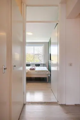 a door leading to a bedroom with a bed at Amsterdam Centraal in 10 minutes - nearby metro in Amsterdam
