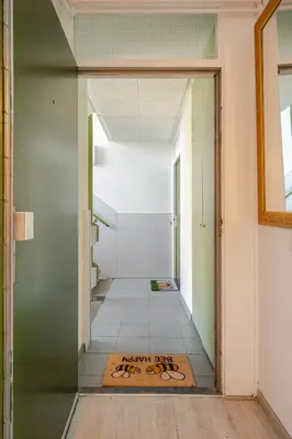 a hallway with a door with a mat on the floor at Amsterdam Centraal in 10 minutes - nearby metro in Amsterdam