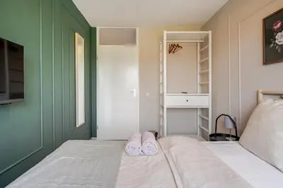 a pair of slippers sitting on a bed in a bedroom at Amsterdam Centraal in 10 minutes - nearby metro in Amsterdam