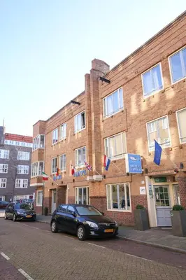 a black car parked in front of a brick building at Hotel Flipper Amsterdam in Amsterdam