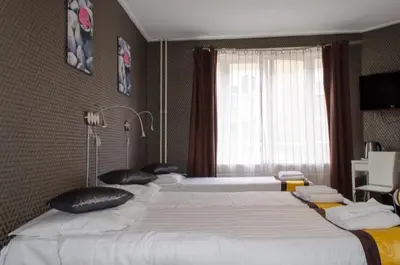 a hotel room with two beds and a window at Hotel Flipper Amsterdam in Amsterdam