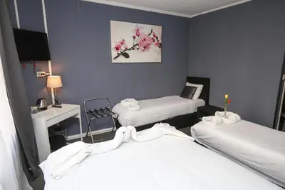 a hospital room with two beds and a desk at Hotel Flipper Amsterdam in Amsterdam