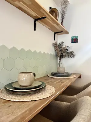 a dining room table with plates and bowls on it at Tiny House in center Aalsmeer I Close to Schiphol & Amsterdam in Aalsmeer