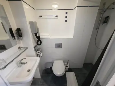 a small bathroom with a toilet and a sink at Hotel Washington in Amsterdam