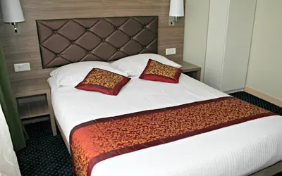 a hotel room with a large bed with two pillows at Hotel Washington in Amsterdam