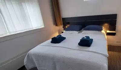 two blue bags sitting on a bed in a bedroom at Bickersbed in Amsterdam