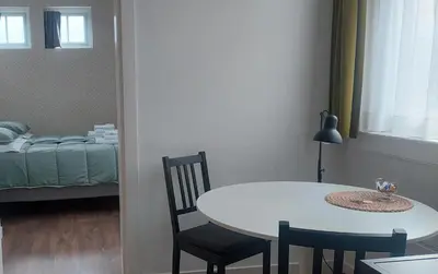 a room with a table and chairs and a bed at Bickersbed in Amsterdam