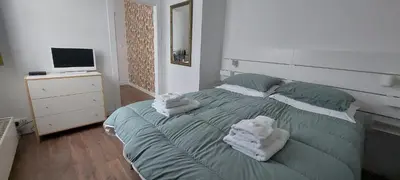 a bedroom with a green bed with towels on it at Bickersbed in Amsterdam