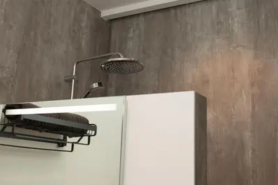 a bathroom with a white cabinet and a shower at Het Groeneveld in Oudkarspel