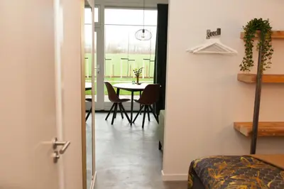 a room with a table and a dining room at Het Groeneveld in Oudkarspel