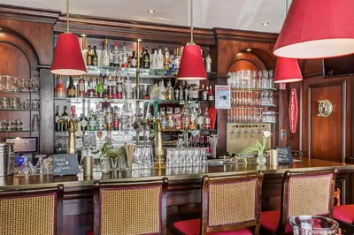 a bar with a lot of bottles of alcohol at Hotel Victoria in Bergen aan Zee